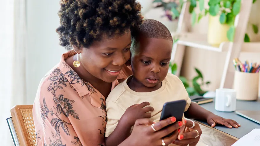 Person with child in lap opening a new WhatsApp message