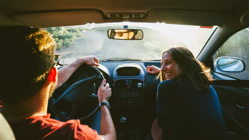 Couple driving through the woods