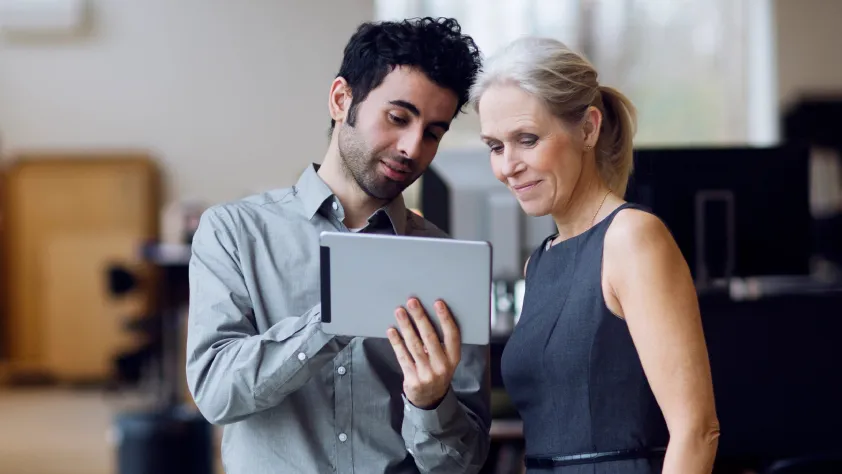 Person showing colleague a company blog post shared by a bot