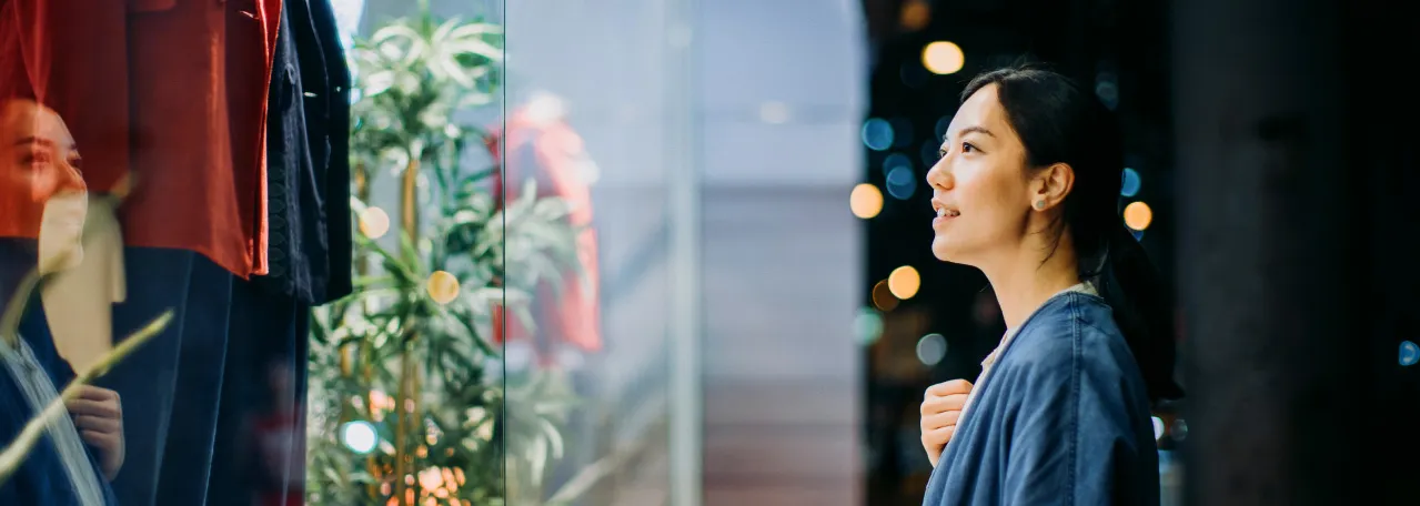 Person looking at clothes through store window