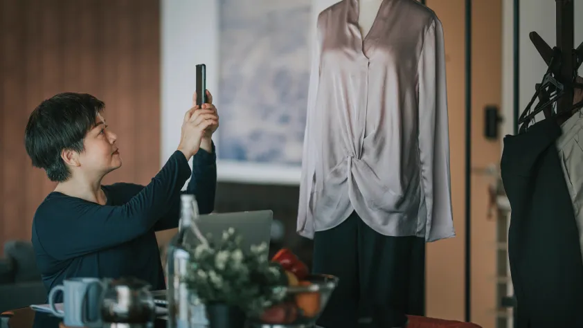 Person taking picture of an outfit on a mannequin