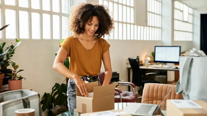 Person in office putting together a package to send out