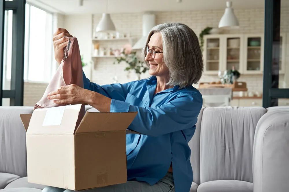 woman at home opening her package