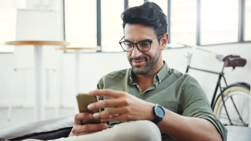 Person sitting at desk while opening a WhatsApp message from a business