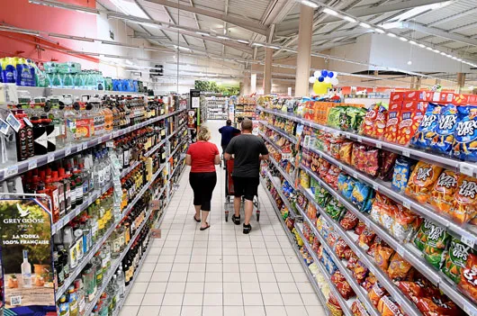 People in the aisle of the supermarket