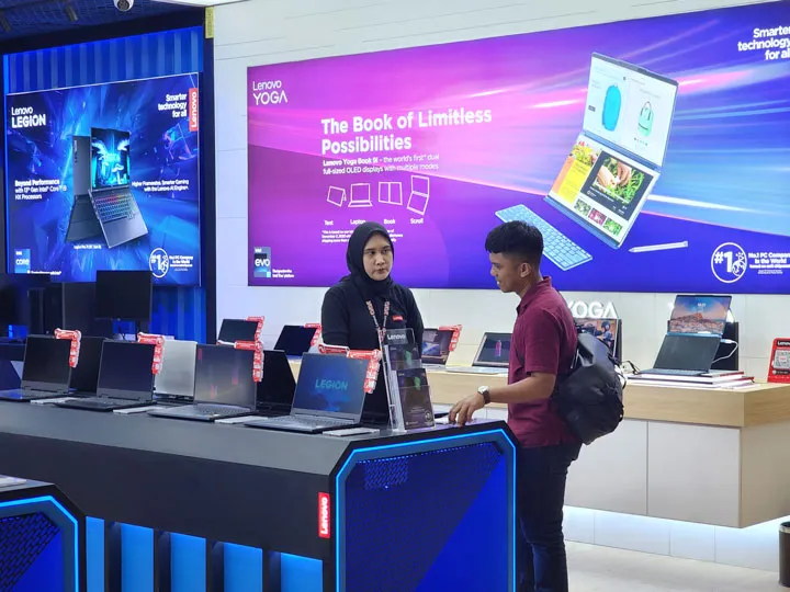 A person inquiring for information from a Lenovo staff member.