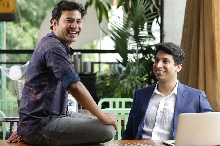 Two smiling businessmen in an office