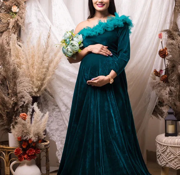 A woman in an elegant green dress with a beautiful backdrop