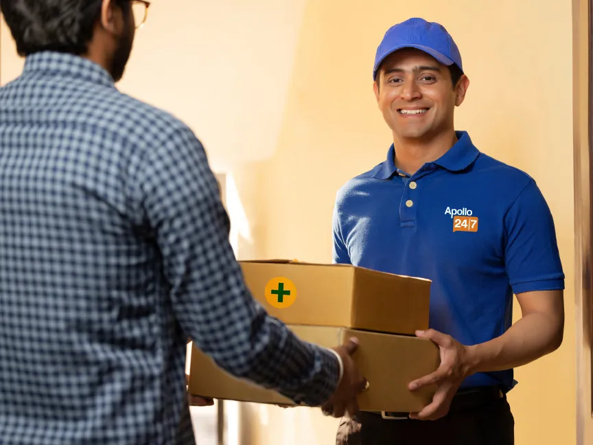 A man wearing an Apollo 24|7 shirt delivering packages