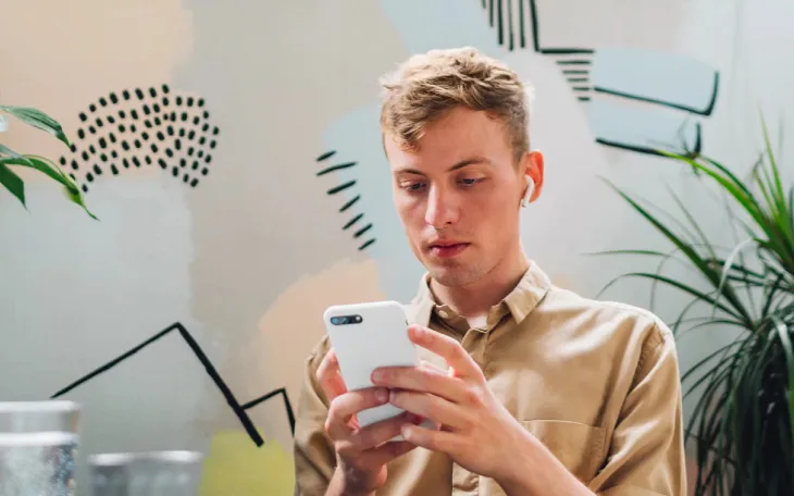 Person at desk looking at automated message through WhatsApp