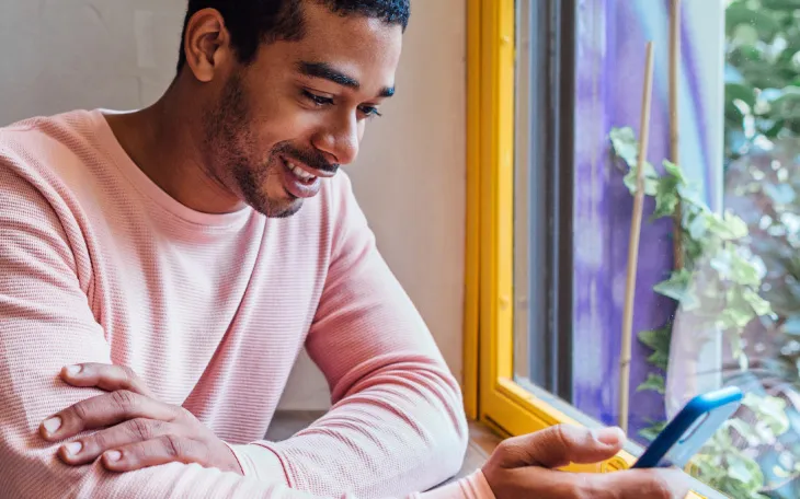 Person sitting in cafe sending messages through WhatsApp