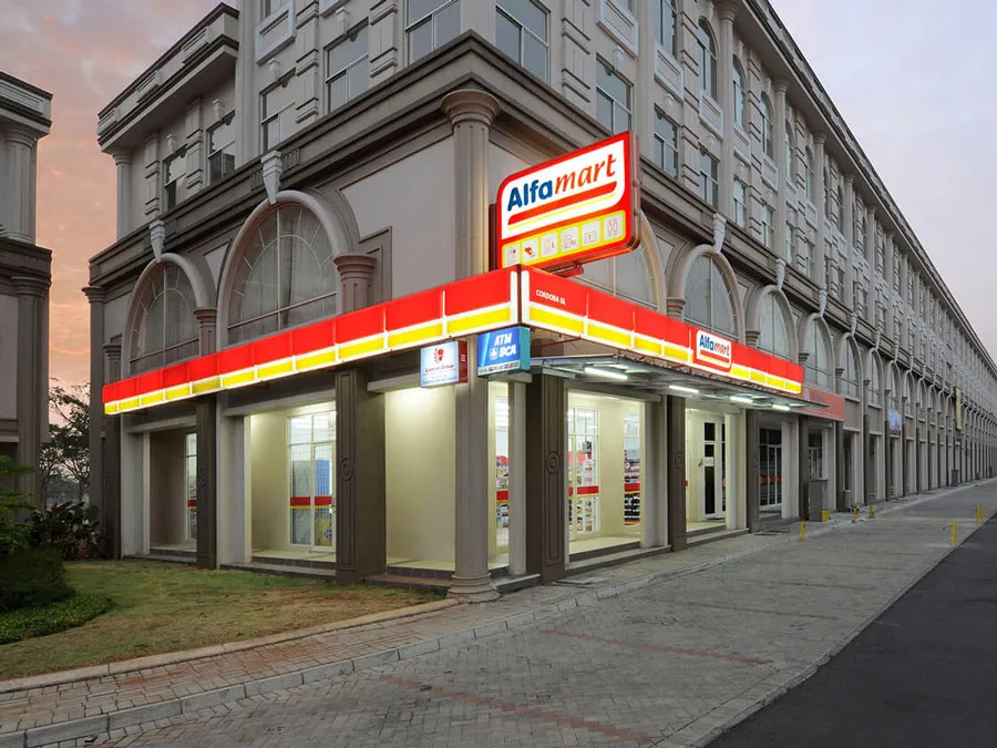 Alfamart convenience store entrance with signage and glass door