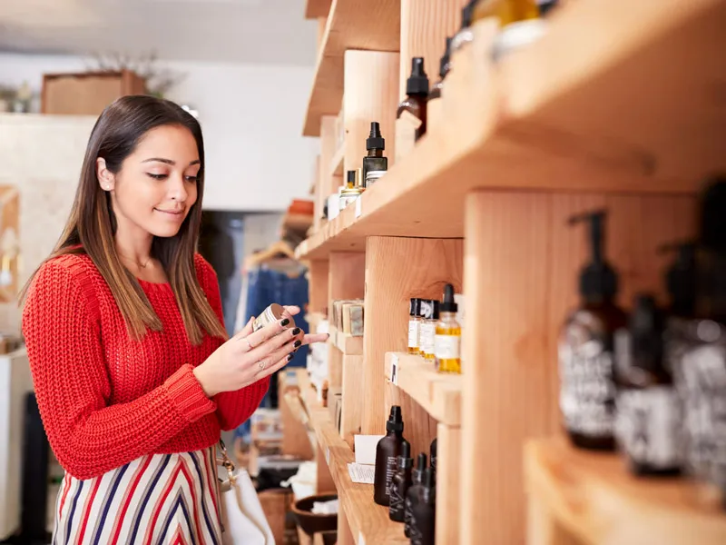 woman browsing bath and beauty products on store shelf