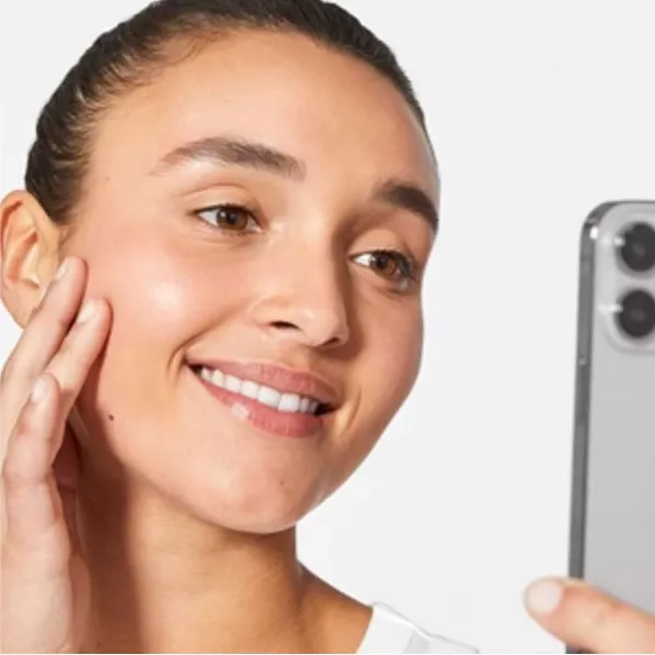 Woman looking at her reflection in a phone