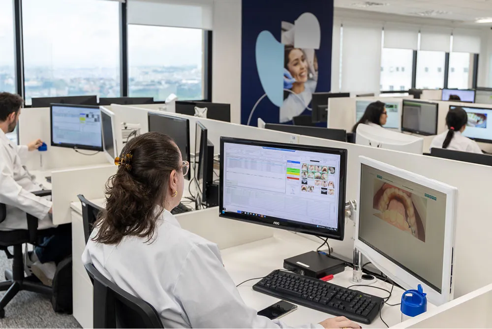 A woman sitting at her office desk working on her assignment