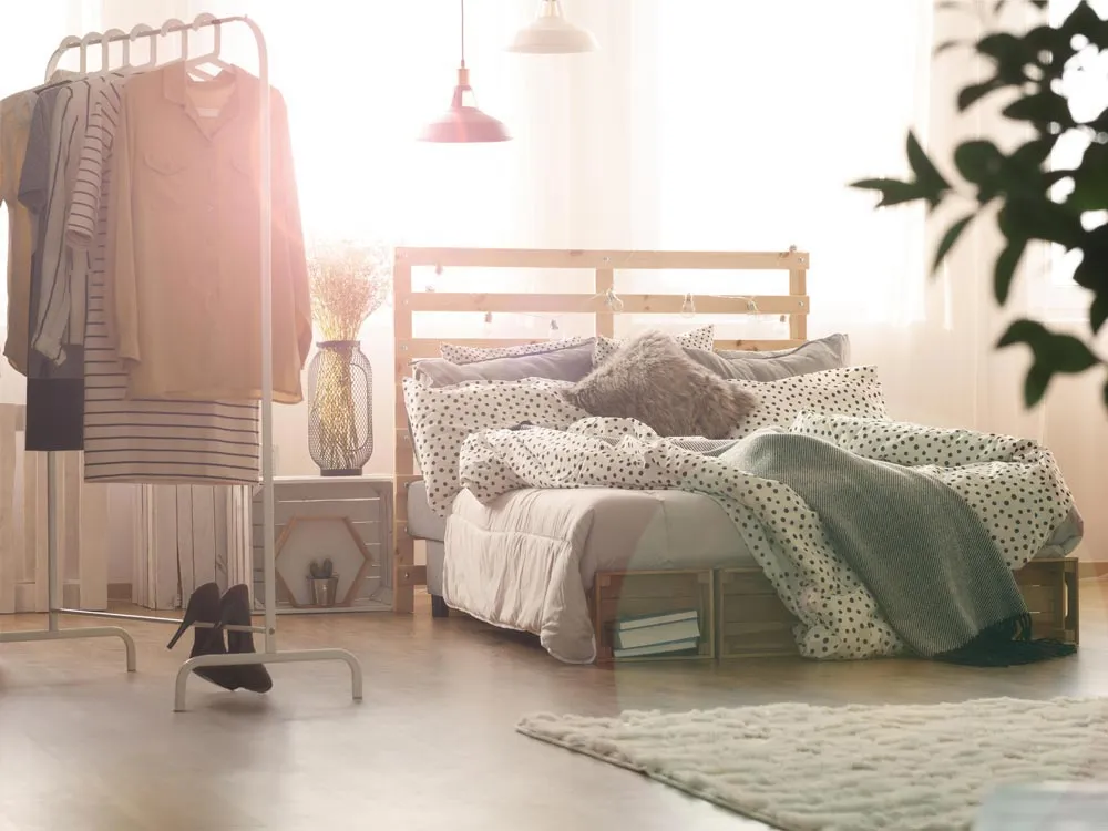 Sincere company showroom displaying a furnished room with a bed and clothing rack of the left side