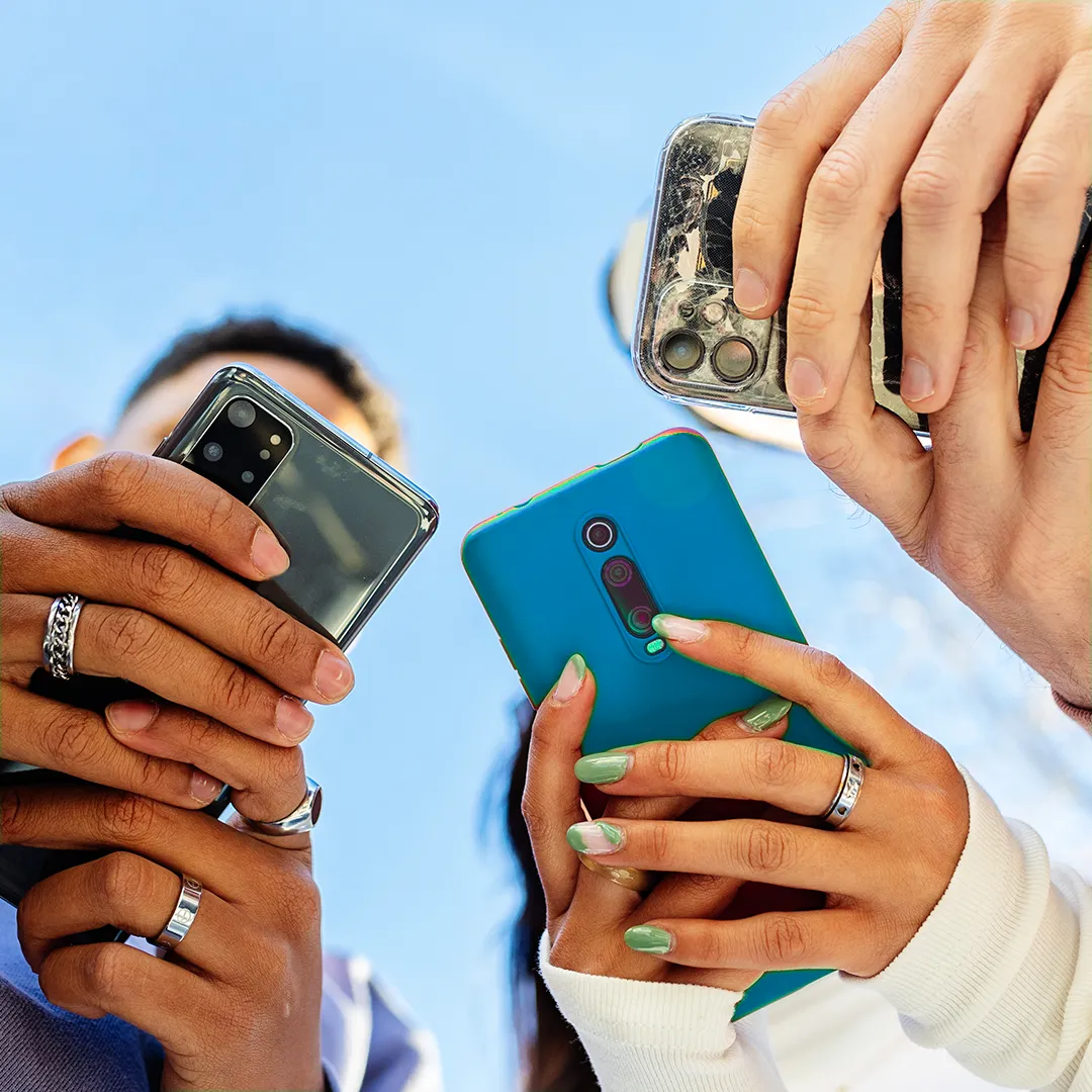 People holding their mobile phones.