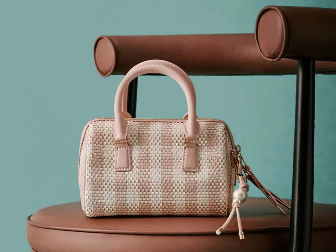 A nice handbag on a chair.