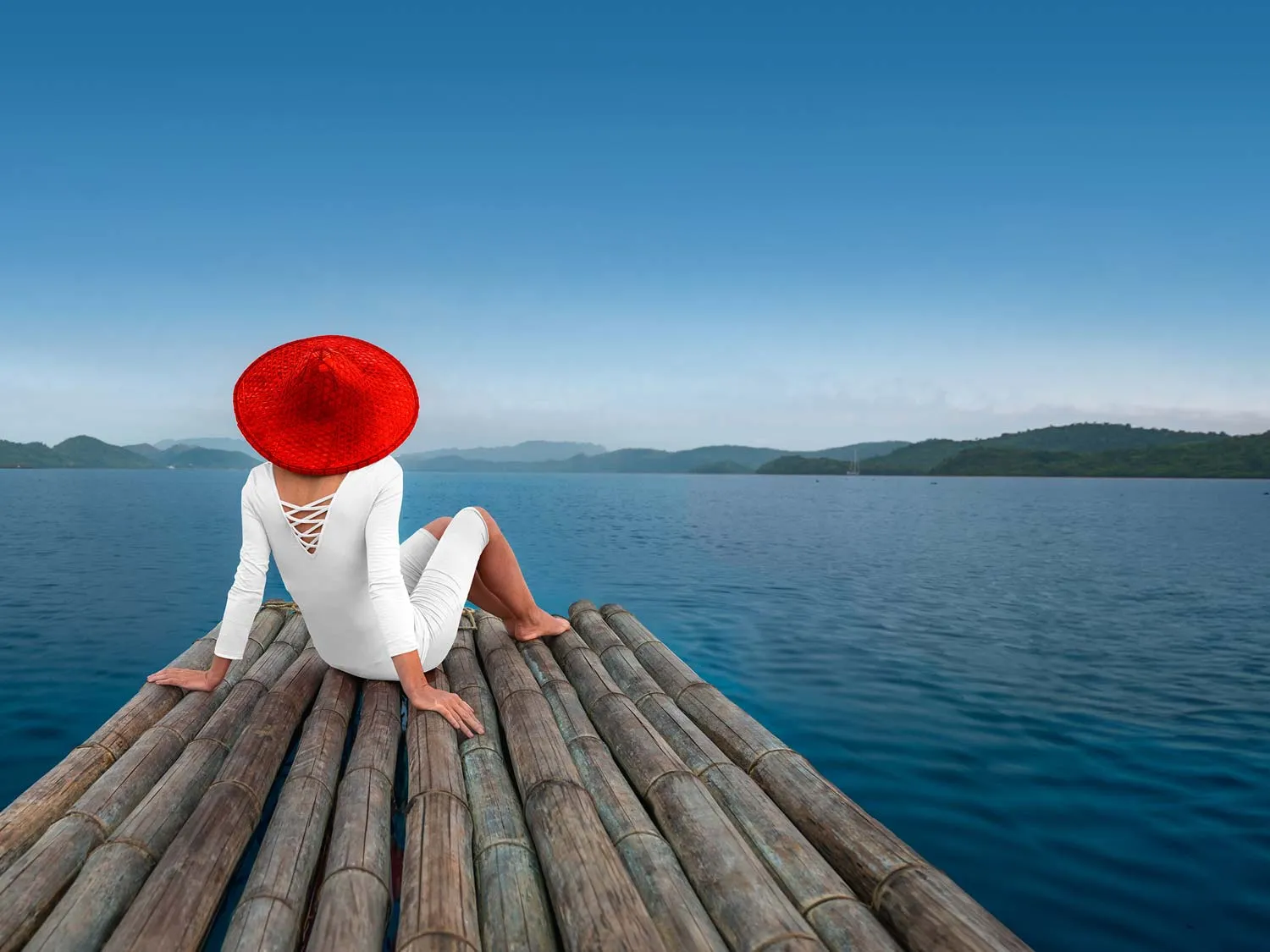 A woman sitting on a dock.